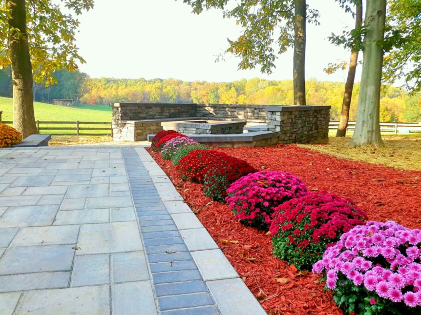 Fall color with Techo Bloc paver patio and large fire pit with seating area